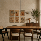 Clérachic chandelier in chrome hung over a dining table set beneath a gallery wall of framed prints.