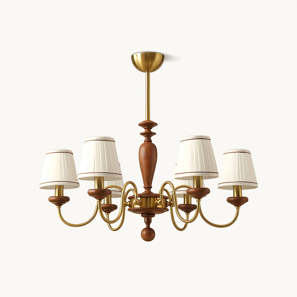 Gold and walnut chandelier with pleated white fabric shades on curved brass arms, hung from a gold canopy on a plain white backdrop, from Clérachic.