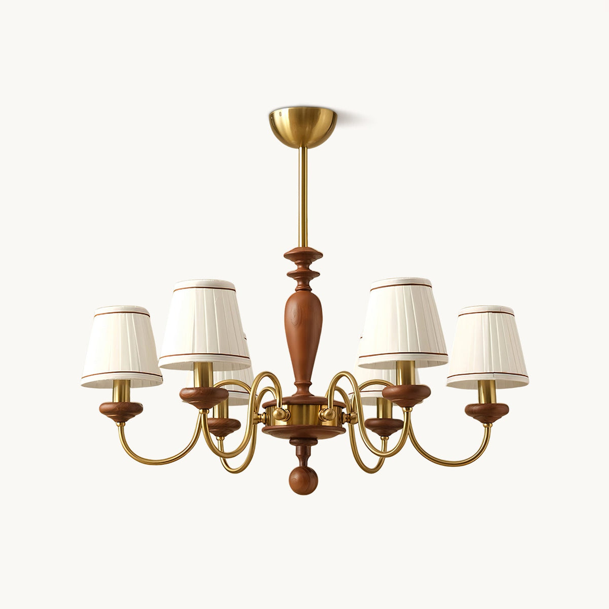 Gold and walnut chandelier with pleated white fabric shades on curved brass arms, hung from a gold canopy on a plain white backdrop, from Clérachic.