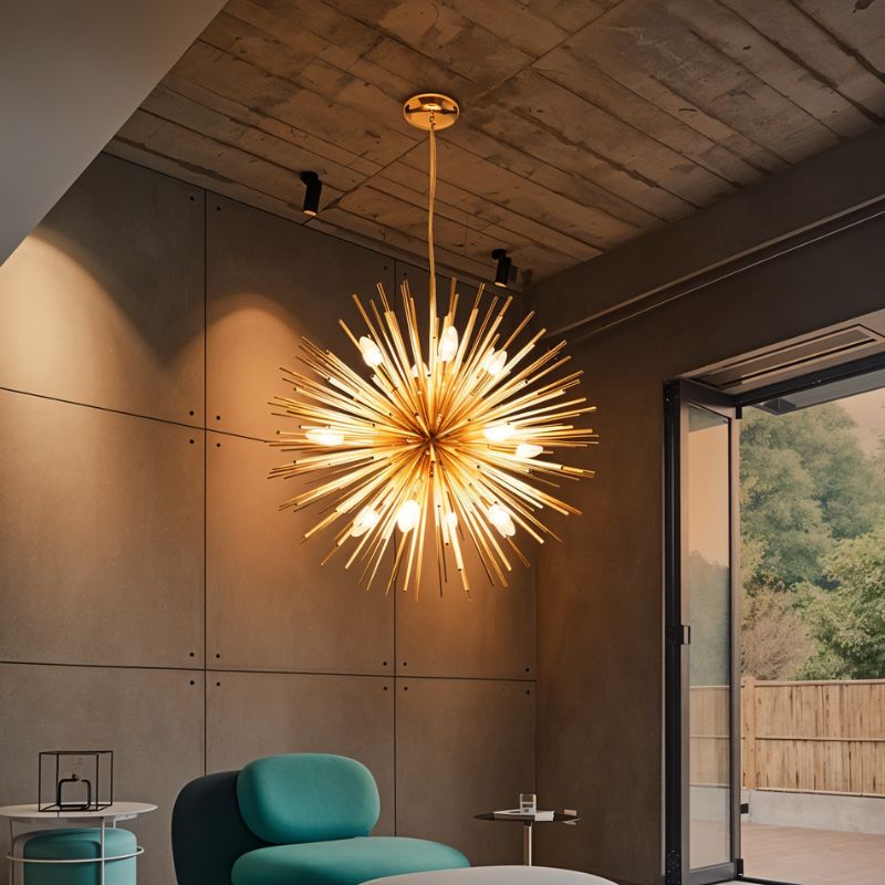 Clérachic gold spike chandelier glowing above a teal lounge chair in a room with concrete panel walls.