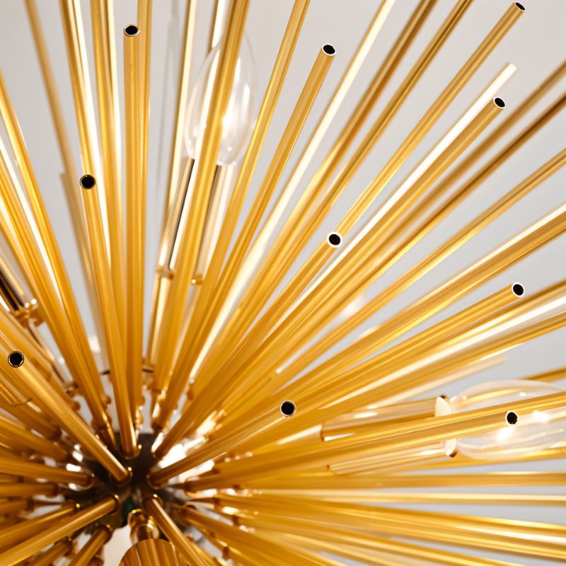 Close view of Clérachic gold spike chandelier, with open-ended slim brass tubes radiating around candle bulbs.