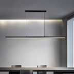 Clérachic black linear LED pendant over a dining table, its single slim bar glowing softly against a grey wall.