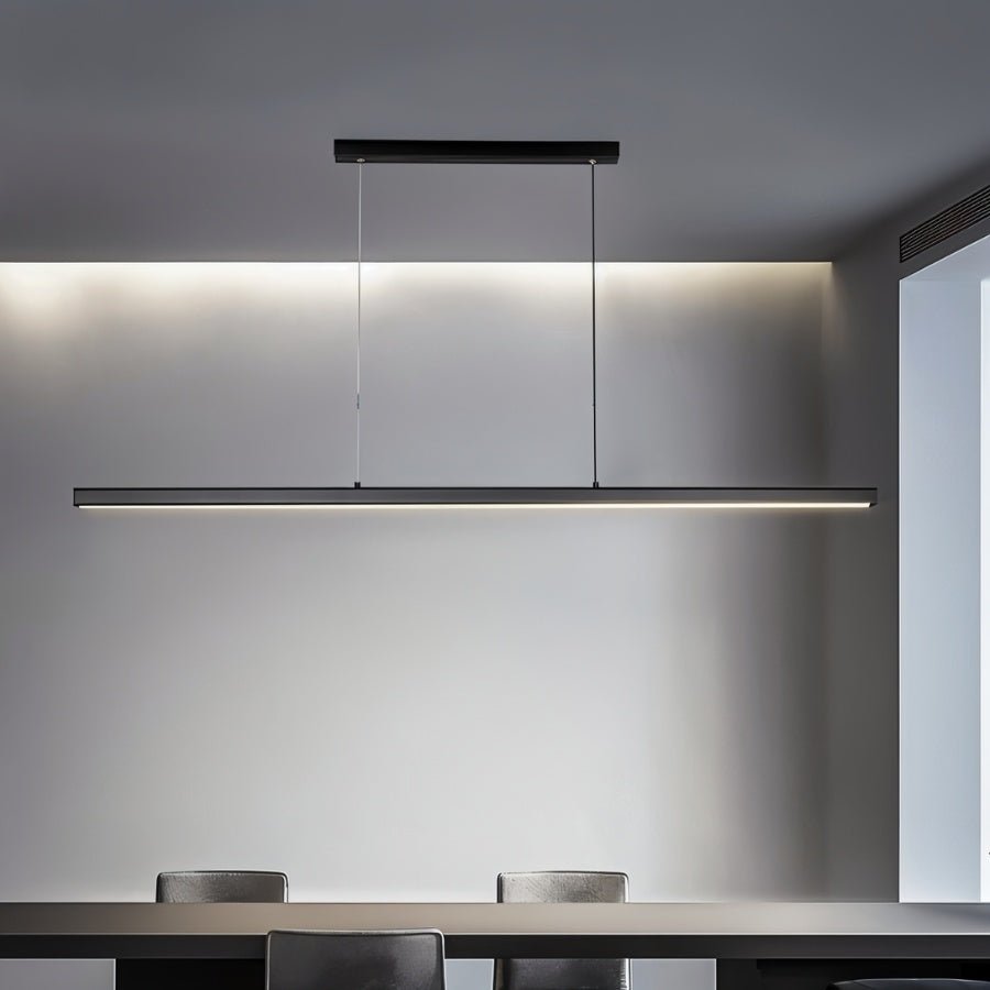 Clérachic black linear LED pendant over a dining table, its single slim bar glowing softly against a grey wall.