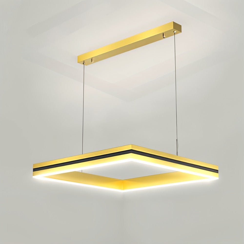 Clérachic single gold square LED pendant with a black inner band, hung from a gold ceiling bar on two cables.
