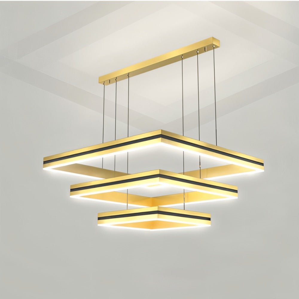 Clérachic three-tier gold square LED chandelier with black bands, hung from a long gold ceiling bar on six cables.
