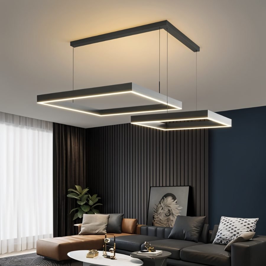 Clérachic two black square LED rings at offset heights, hung from an L-shaped ceiling bar above a dark leather sofa.