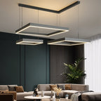 Clérachic three black square LED rings at different heights from an angled ceiling bar, over a dark green panelled lounge.