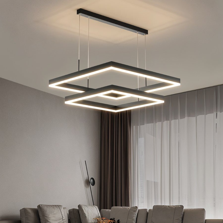Clérachic two-tier black square LED chandelier hung from a slim ceiling bar above a sofa, with curtains behind.