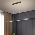 Clérachic grey-black linear LED pendant with a copper-toned end cap, hung on two cables against a dark panelled wall.