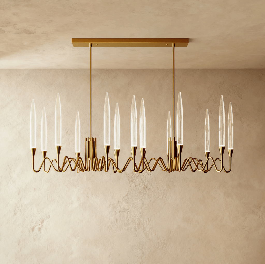 Clérachic compact linear brass chandelier with twelve clear glass shades on looping arms, hung from two rods on a rectangular canopy.