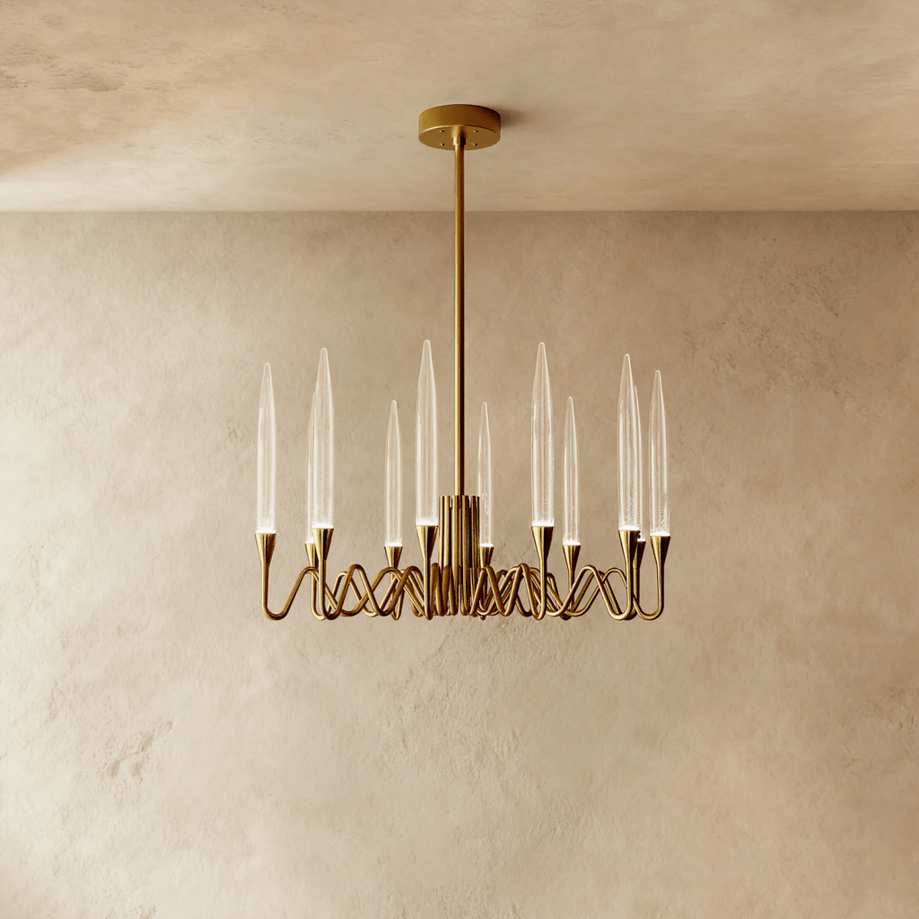 Clérachic small round brass chandelier with twelve clear glass candle shades on looping arms, hung from a rod and round canopy.