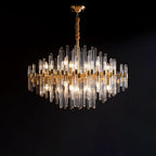 Against a black backdrop, this Clérachic chandelier shows its brass arms, clear glass rods and candle-style bulbs in a diamond-shaped outline.