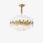 Clérachic chandelier of brass arms and clear glass rods on a light backdrop, hanging from a ceiling plate on a twisted gold-brown cover.