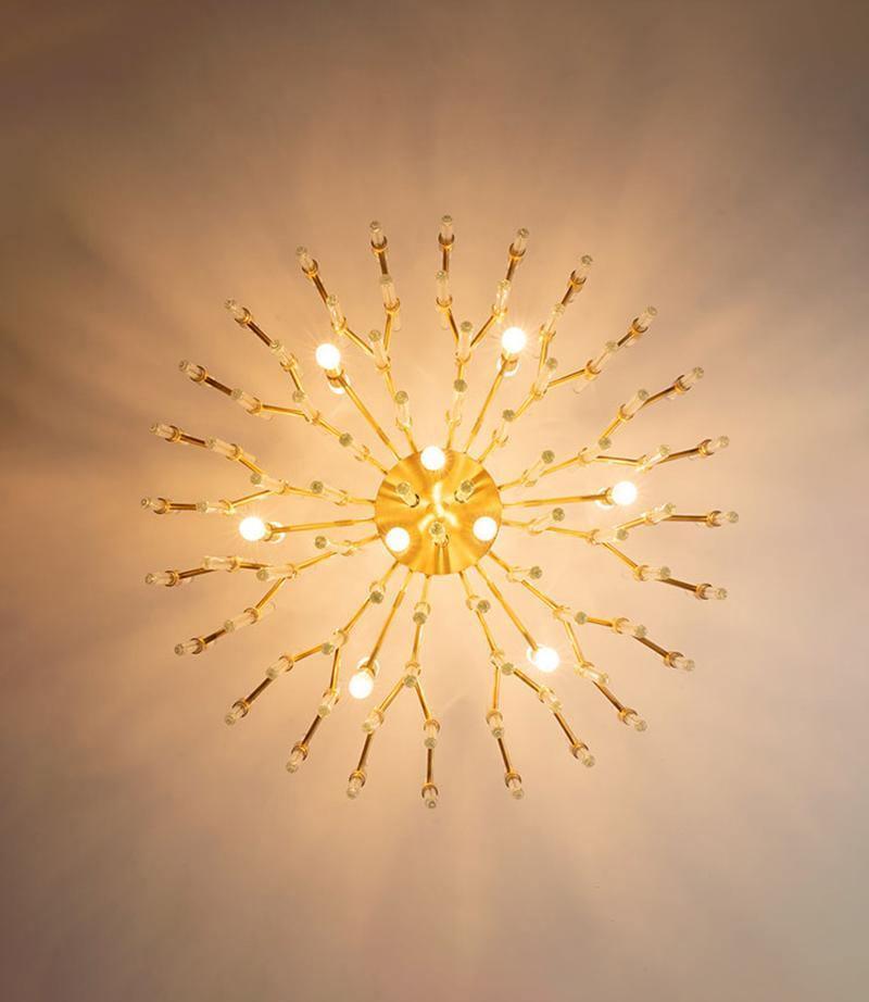 Looking straight up at this Clérachic brass fixture, bulbs and glass-tipped arms radiate from the centre in a sunburst pattern on the ceiling.