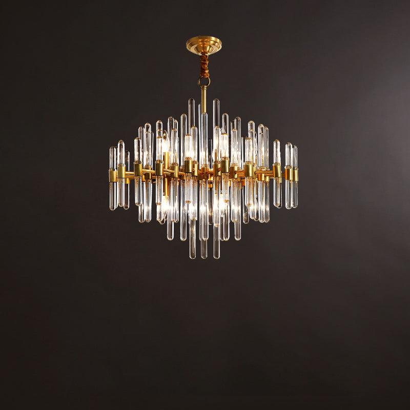 A mid-size Clérachic brass chandelier with several tiers of clear glass rods, hanging on a short rod against a brown studio backdrop.