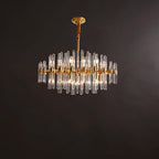 Wide, low Clérachic brass chandelier with a single row of long glass rods, hanging from a short rod against a brown backdrop.