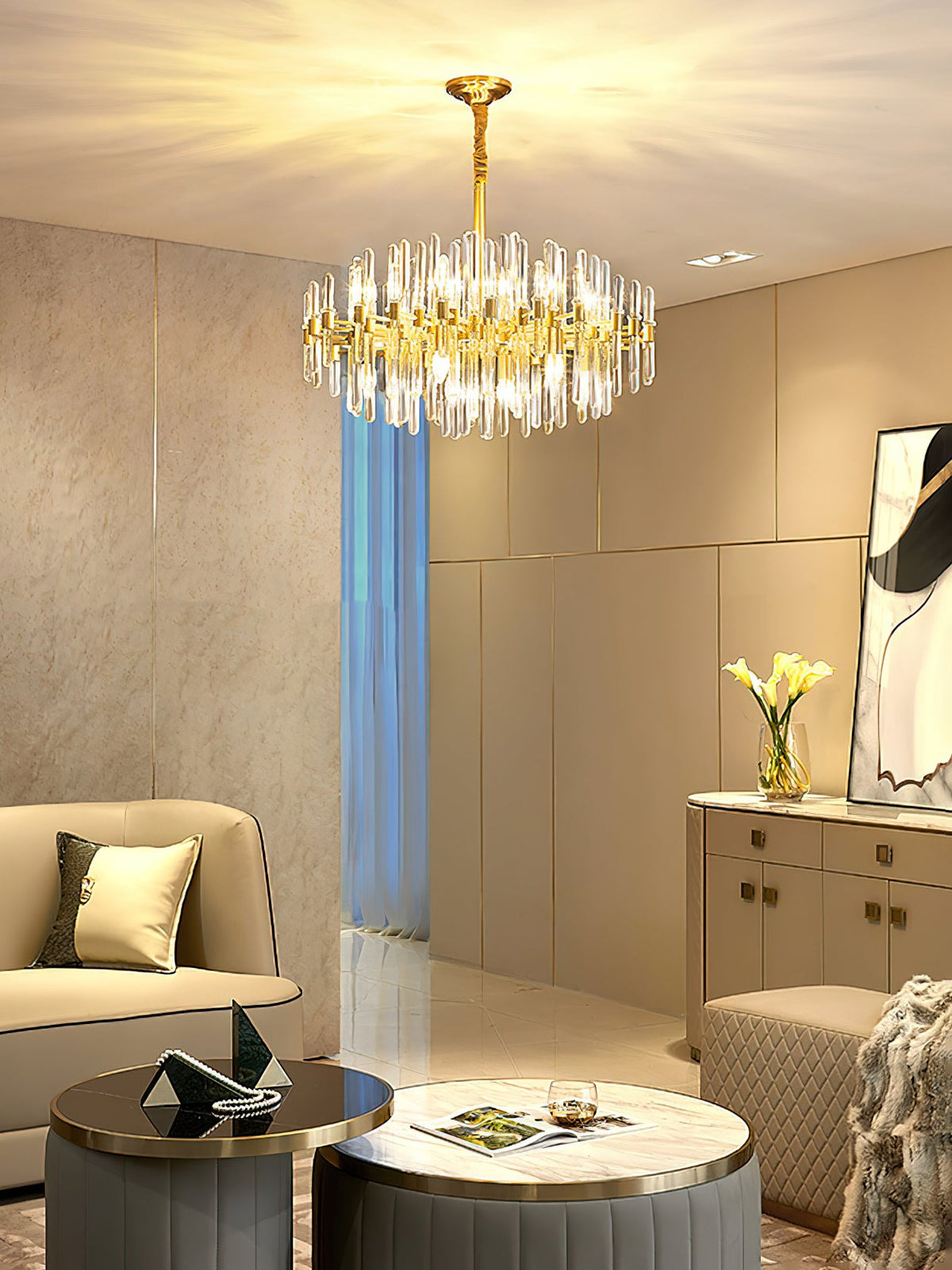 Looking up at this Clérachic brass chandelier in a bright room with a window, a sofa and a low table with magazines below.