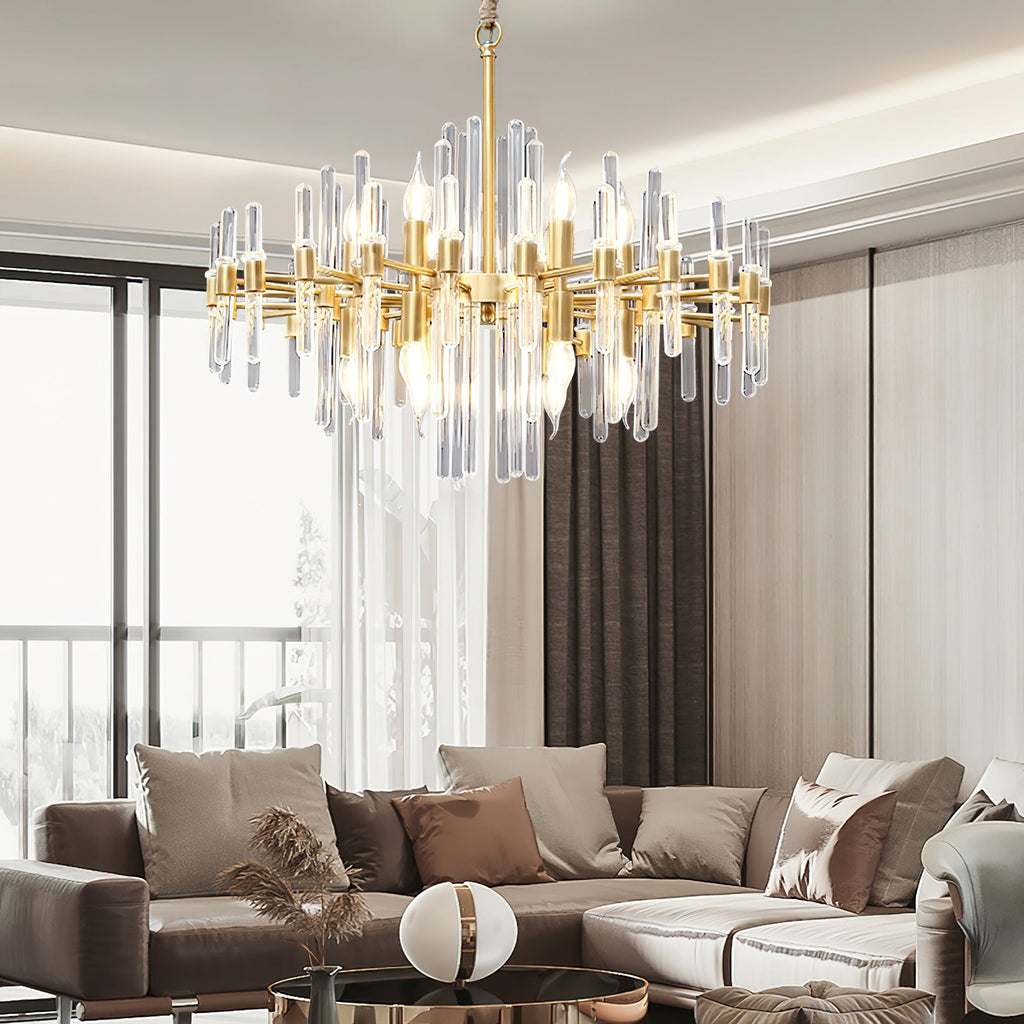 This Clérachic chandelier lit in a modern living room with a large window, with a brown sofa and a round coffee table below.