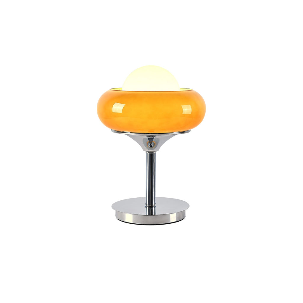 A Clérachic table lamp cut out on white, its orange-amber shade lit from inside and its white globe on top.