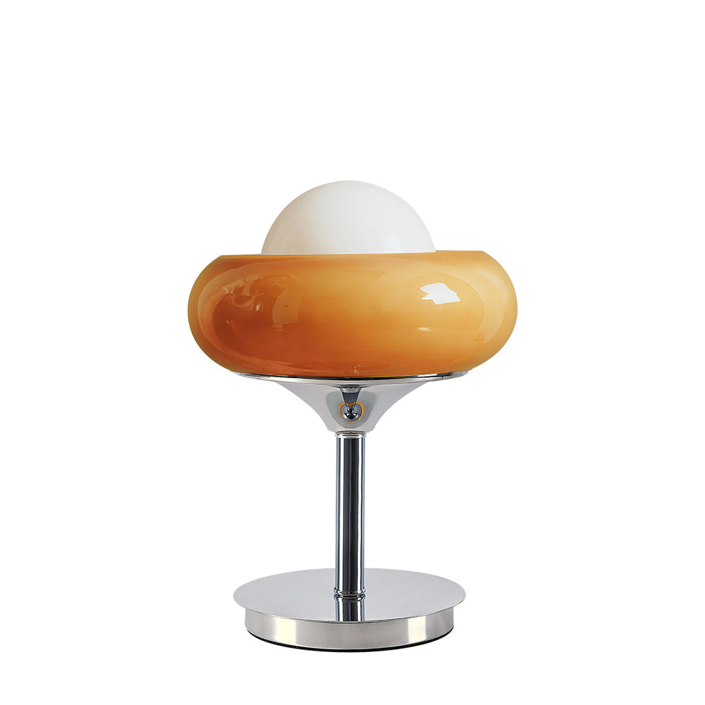 A Clérachic table lamp in a deeper amber tone cut out on white, with the white globe above the glossy shade and a chrome stem below.