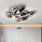 Clérachic 6-head Chrome Ceiling Light above vertical wall panels, five chrome pebbles flush and one hanging.