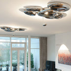 Two Clérachic 6-head Chrome Ceiling Lights in a living room above terrace windows and warm abstract art.