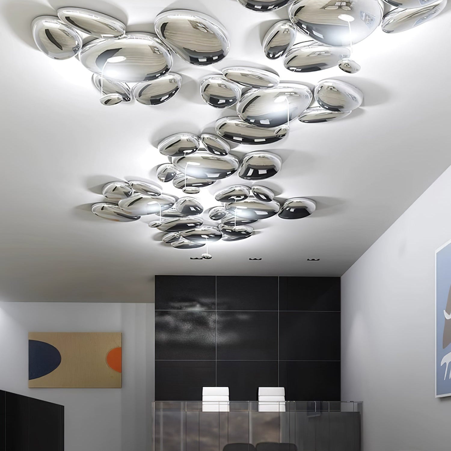 Several Clérachic Chrome Ceiling Lights cluster across a lobby ceiling near a dark grid wall and art.