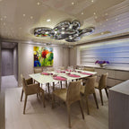 Clérachic 6-head Chrome Ceiling Light over a set dining table, chrome pebbles reflecting a colorful painting.