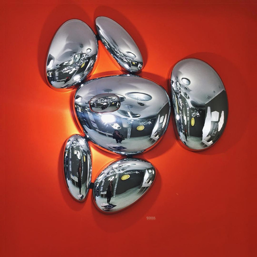 Clérachic 6-head Chrome Ceiling Light on an orange wall, a warm LED halo behind the mirrored pebble cluster.