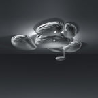 Clérachic 6-head Chrome Ceiling Light on a dark ceiling, five chrome pebbles flush and one smaller pebble hanging.