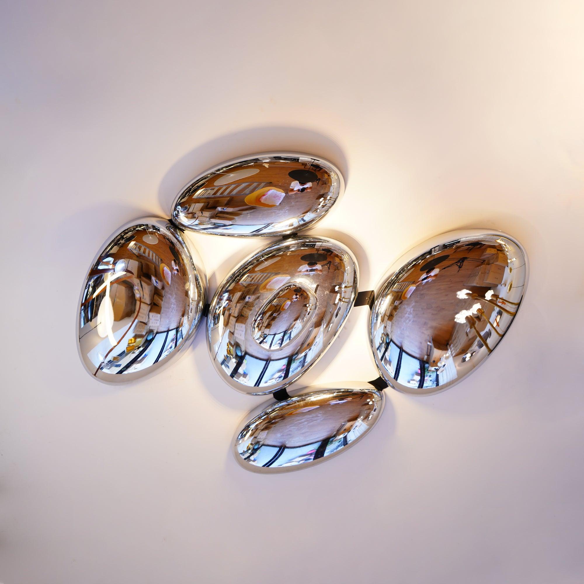 Clérachic 5-head Chrome Ceiling Light, five overlapping chrome pebbles glowing on a plain white ceiling.