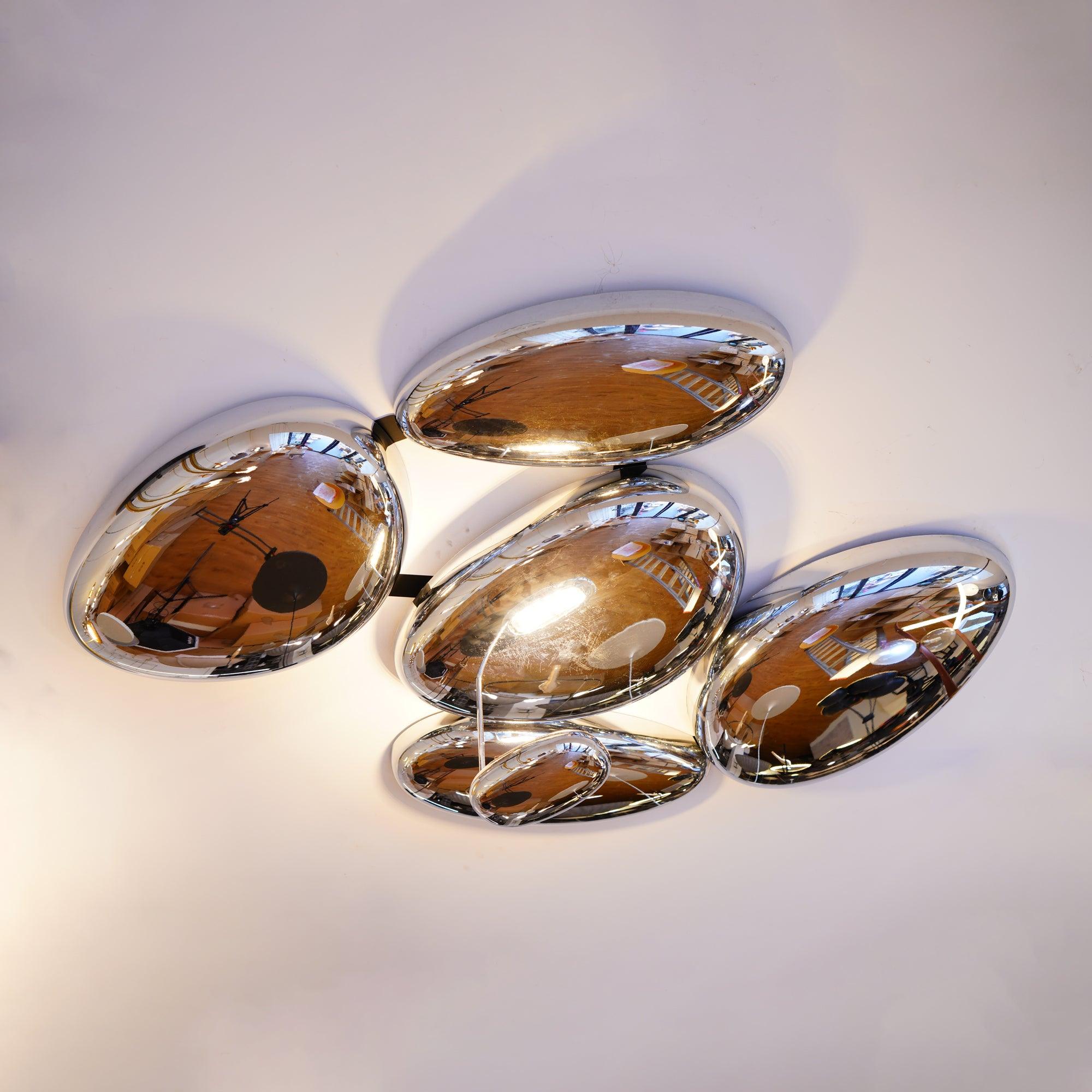 Looking up at the Clérachic 5-head Chrome Ceiling Light, five chrome pebbles reflecting wood floors.