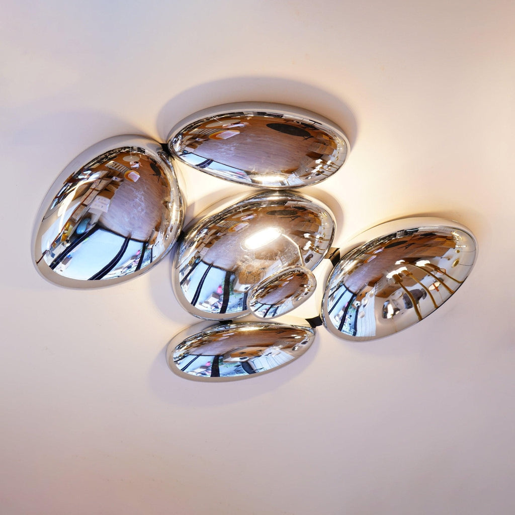 Worm's-eye view of the Clérachic 5-head Chrome Ceiling Light, chrome pebbles reflecting windows on a white ceiling.
