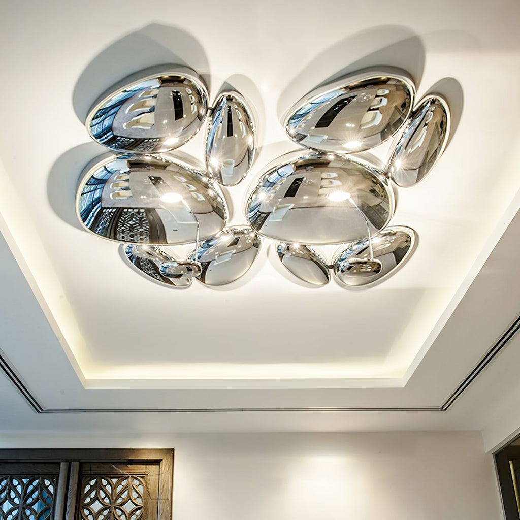 Two Clérachic 6-head Chrome Ceiling Lights on a tray ceiling beside a dark geometric lattice door.