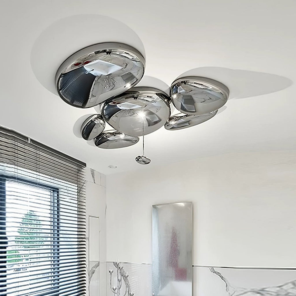Clérachic 6-head Chrome Ceiling Light above marble wall tiles, with a small chrome pebble hanging below.