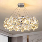 Close view of the chrome-rimmed crystal discs and the five suspension cables on this Clérachic chandelier.