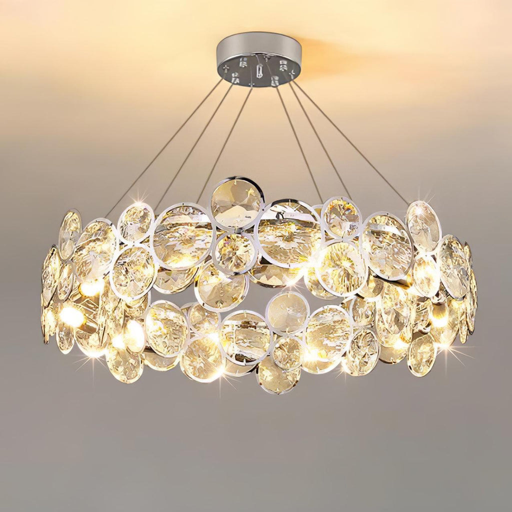 Front view of the lit round Clérachic chandelier, with its two bands of chrome-rimmed crystal discs.