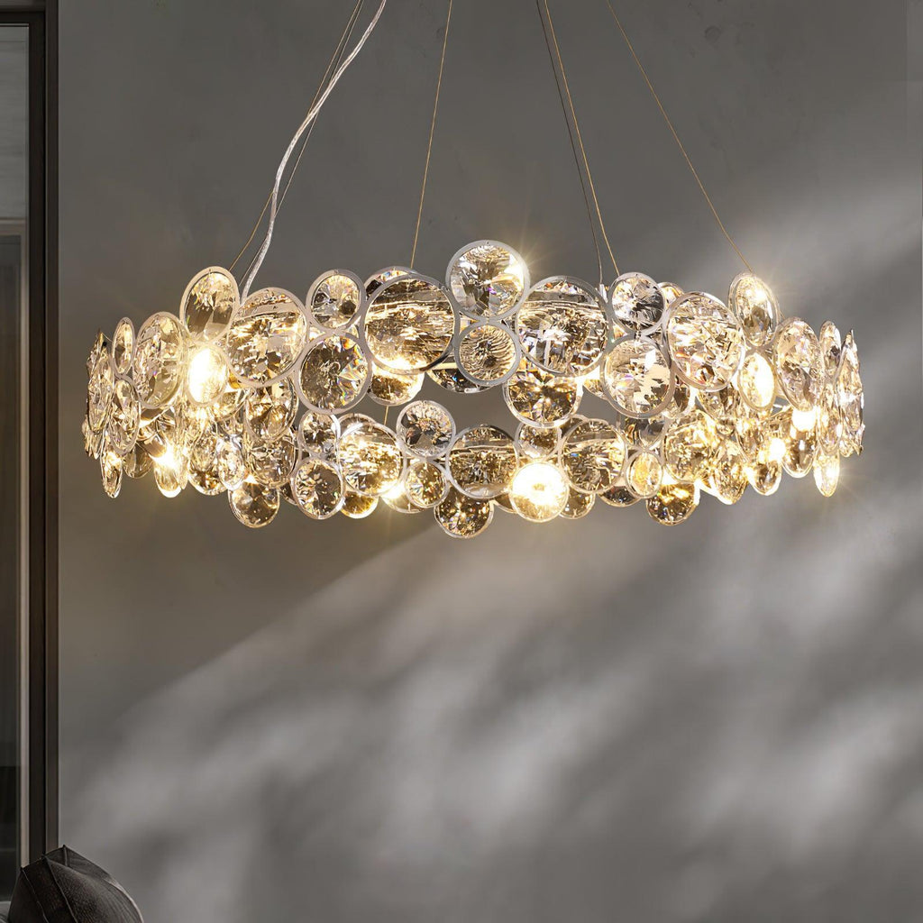 Side view of a Clérachic crystal chandelier lit, with its sparkling discs casting shadows on a grey wall.