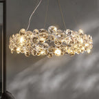 Side view of a Clérachic crystal chandelier lit, with its sparkling discs casting shadows on a grey wall.