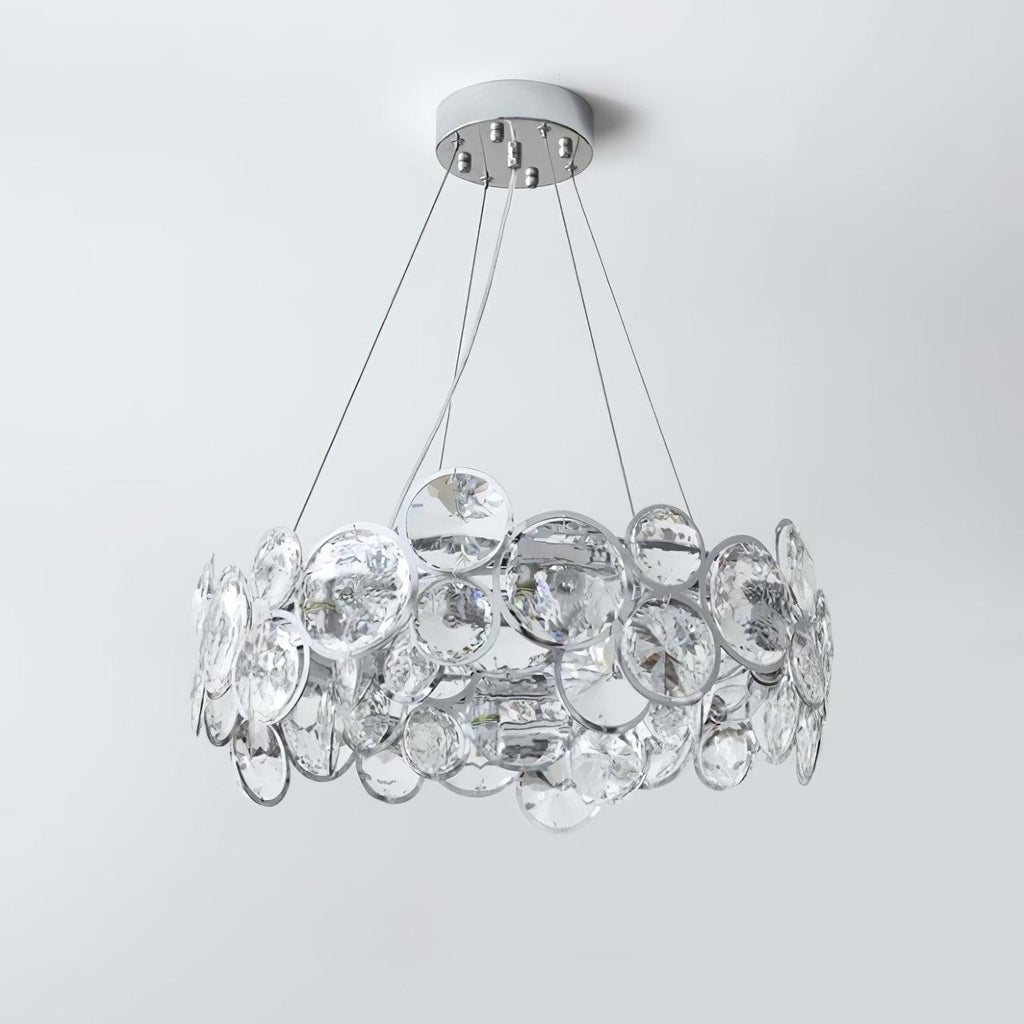 Unlit Clérachic crystal chandelier on a pale grey backdrop, showing the clear discs set in chrome rings.