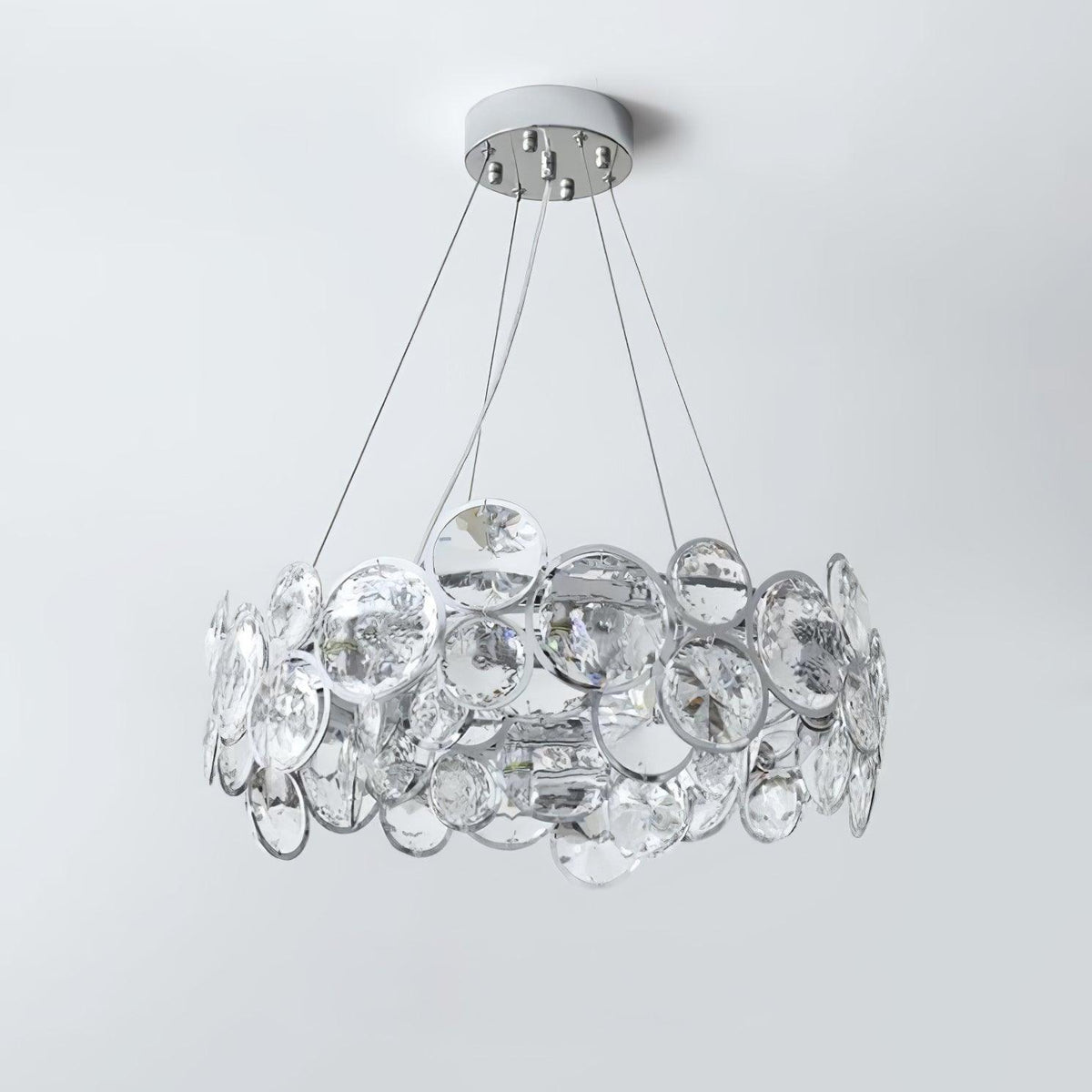Unlit Clérachic crystal chandelier on a pale grey backdrop, showing the clear discs set in chrome rings.