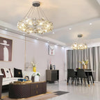Two Clérachic crystal chandeliers light an open-plan living and dining room with a quilted coffee table.