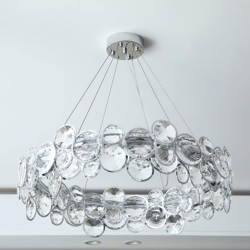 Wide close shot of the round Clérachic chandelier, showing the two layers of crystal discs and its chrome canopy.