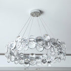 Wide close shot of the round Clérachic chandelier, showing the two layers of crystal discs and its chrome canopy.
