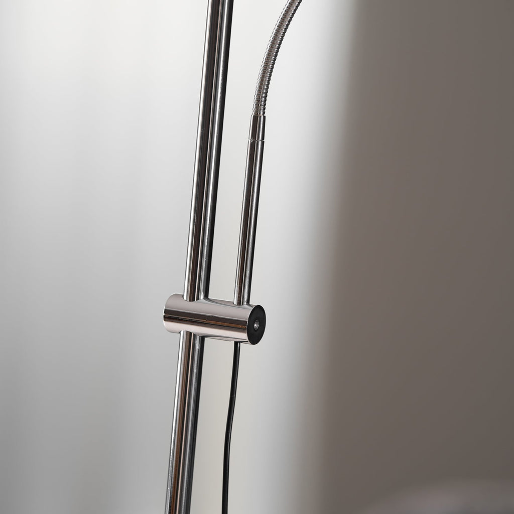 Close view of the chrome poles, sliding collar and flexible neck on this Clérachic floor lamp, with its black cord.