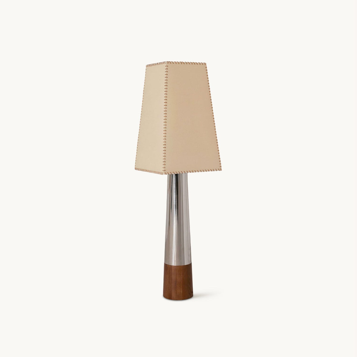 A Clérachic floor lamp on a plain white backdrop, with a tapered beige shade, a slim chrome stem and a dark walnut-coloured base.
