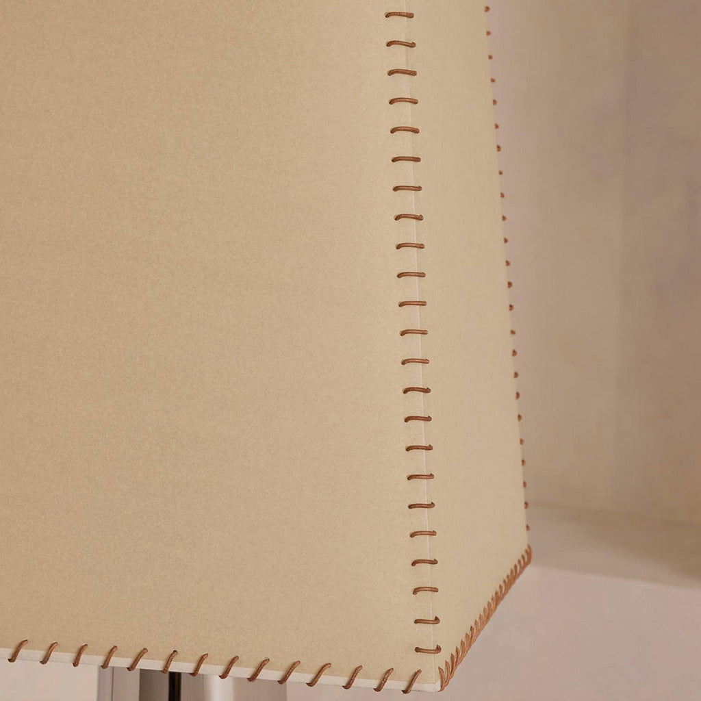 Close view of the hand-stitched seam running down the edge of the beige shade on this Clérachic floor lamp.