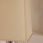 Close view of the hand-stitched seam running down the edge of the beige shade on this Clérachic floor lamp.