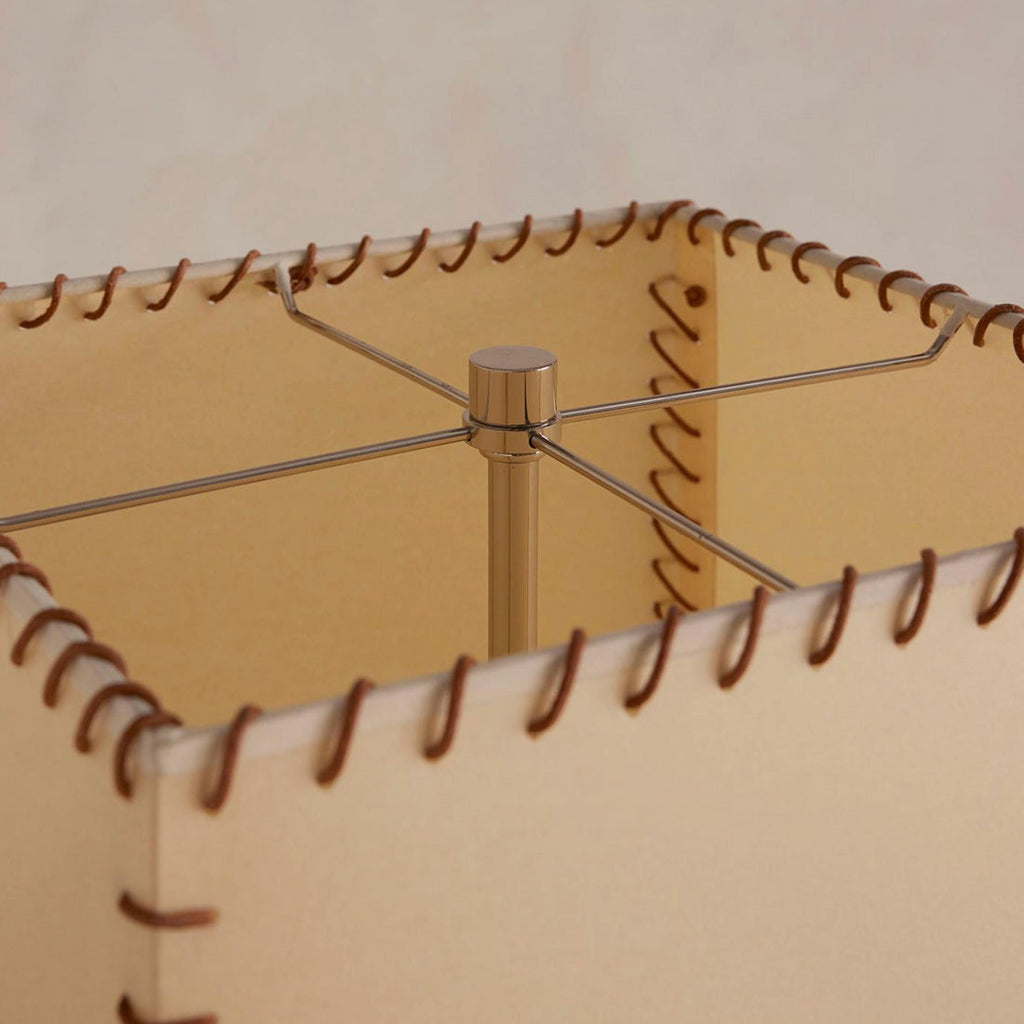Looking down into the shade of this Clérachic floor lamp, where a slim metal frame holds the top of the stem and the stitching shows.