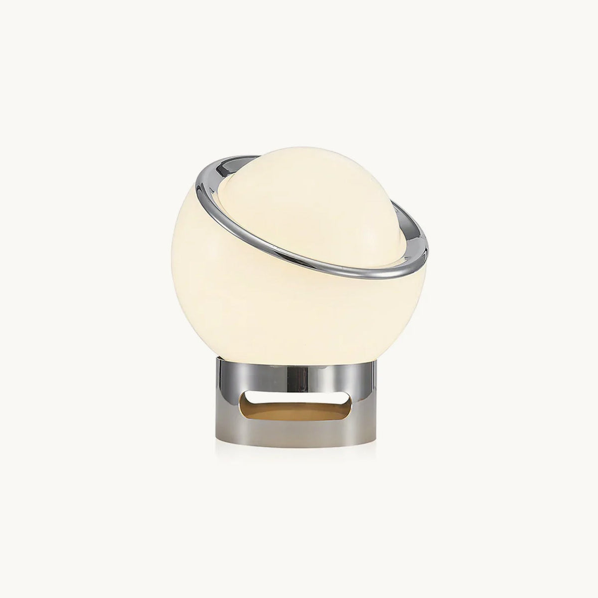 Glowing white glass globe with a tilted chrome ring on a short chrome base, shown on a plain white backdrop as this Clérachic table lamp.